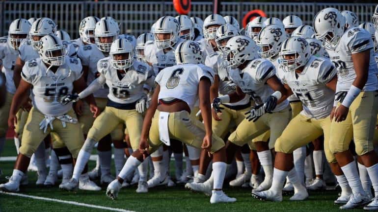 Aug 25, 2017; Ft Lauderdale, FL, USA; St. John Bosco Braves teammates take to the field prior to the game against the St. Thomas Aquinas Raiders at Brian Piccolo Stadium. Mandatory Credit: Jasen Vinlove-USA TODAY Sports